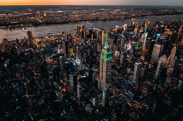 Empire State Building illuminated green at night, New York City cityscape