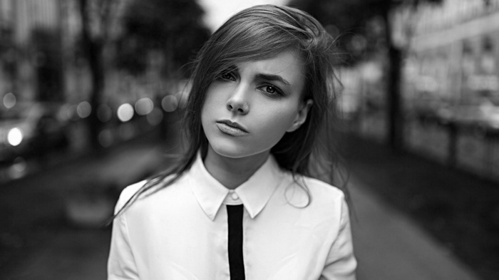 Woman in white shirt with black tie
