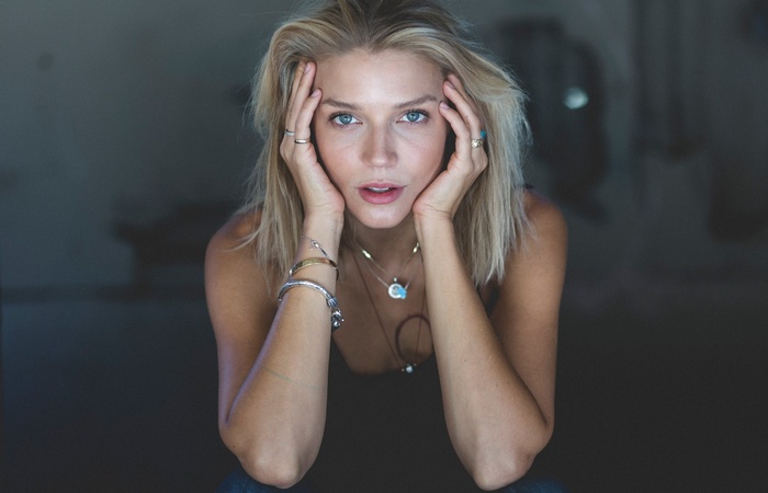 Woman with blonde hair and blue eyes posing