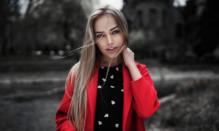 Woman in red coat and black dress