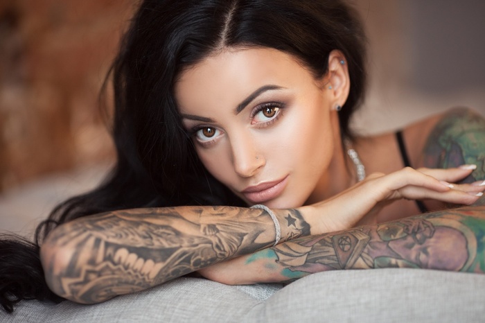 Woman with tattoos and black hair