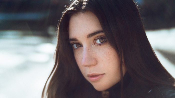 Woman with freckles and long brown hair