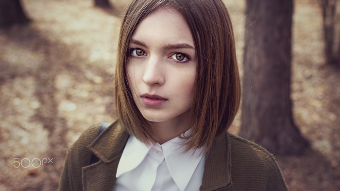 Portrait of a young woman with short brown hair
