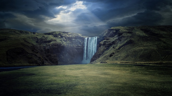 Skogafoss waterfall under dramatic clouds