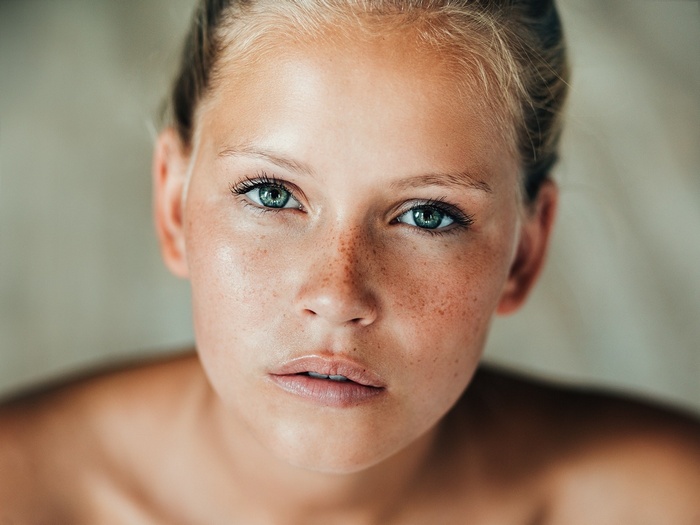 Portrait of a young woman with freckles