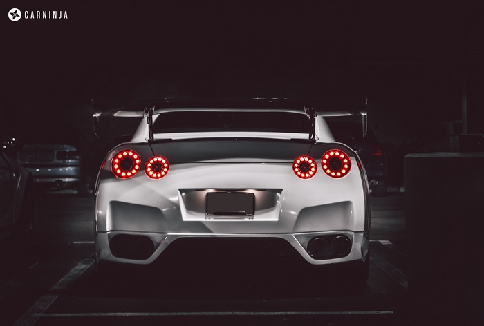 White Nissan GT-R with spoiler at night