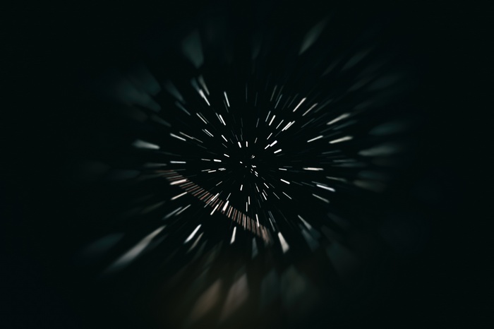 Motion blur effect with light streaks against dark background