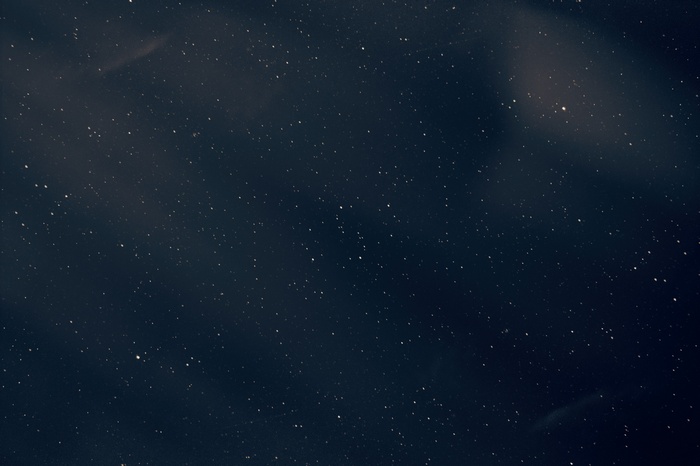 Dark night sky with stars and clouds