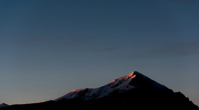Snow-capped mountains at sunset