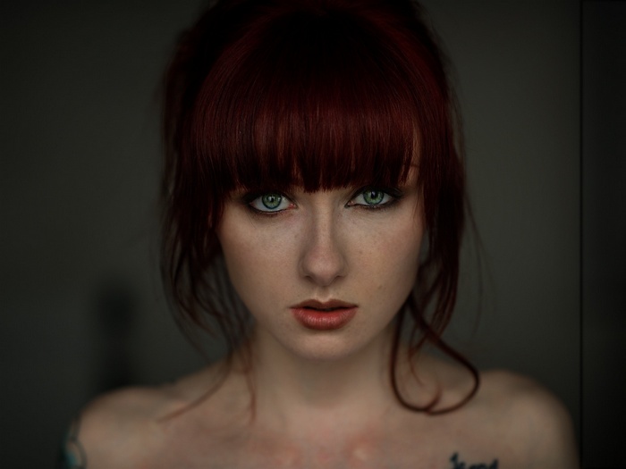 Woman with red dyed hair and green eyes