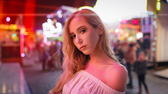 Woman with blonde hair at a night fair
