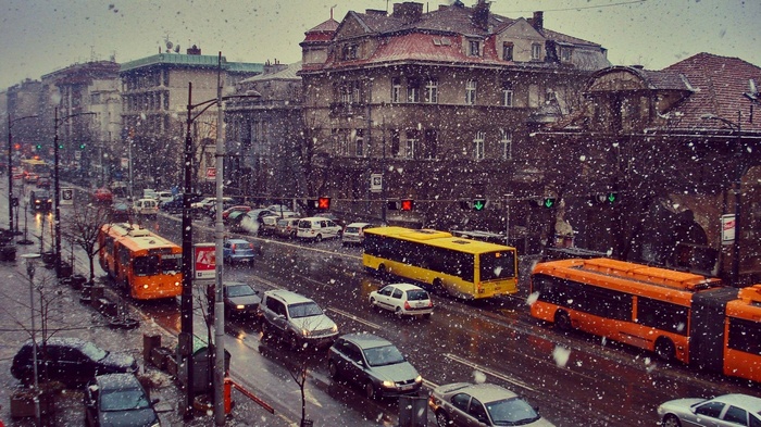 Cityscape with buses and cars in snow