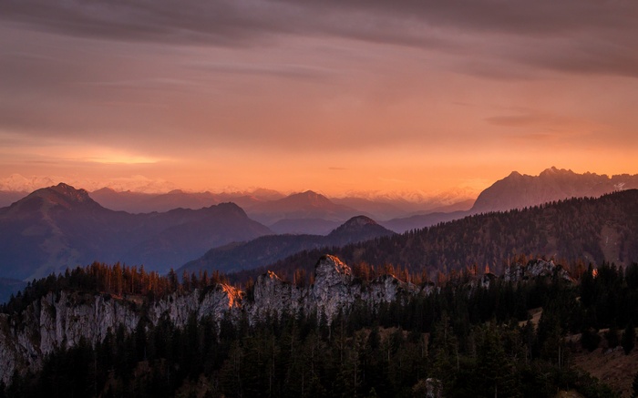 Sunset over mountains and forest landscape