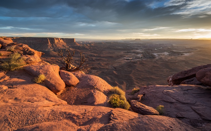 Sunrise over a vast canyon landscape