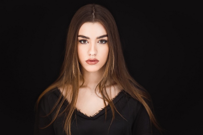 Portrait of a young woman with long brown hair