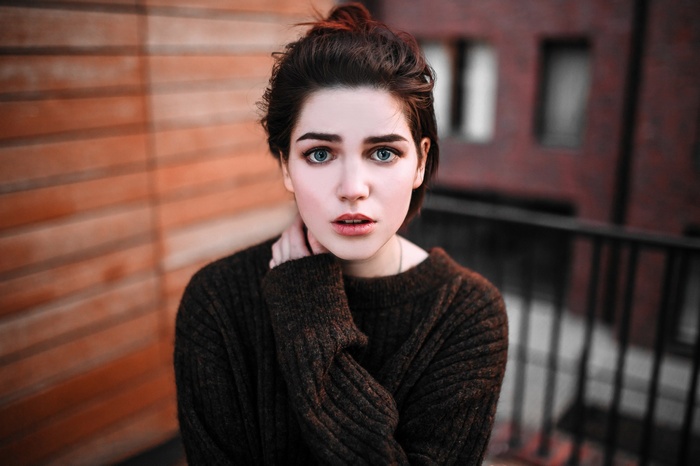 Woman with blue eyes wearing a sweater