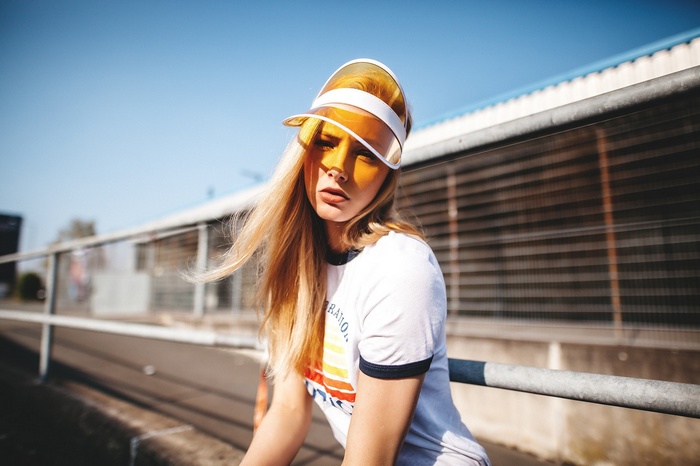 Woman wearing a visor and t-shirt outdoors