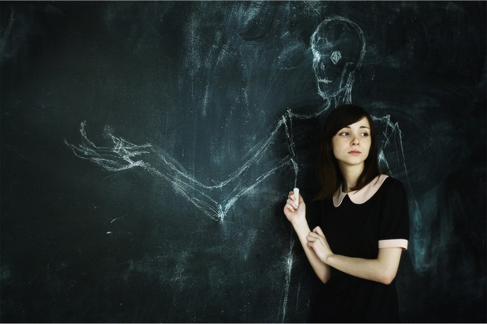 Katya Lischina drawing skeleton on chalkboard