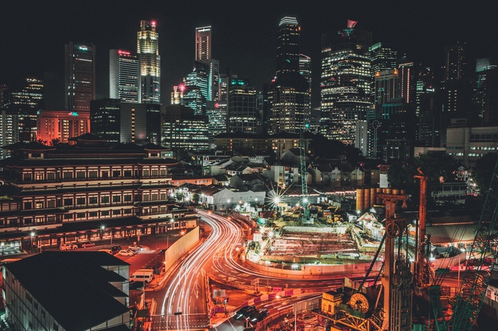 Night cityscape with skyscrapers and light trails