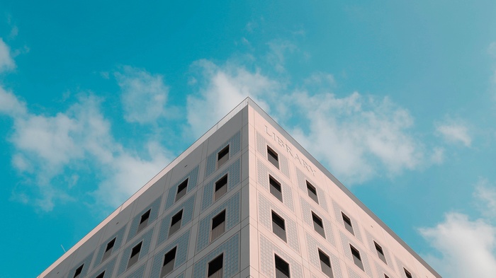 Library building against a blue sky with clouds