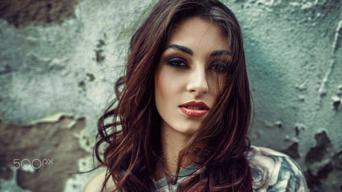 Portrait of a woman with dark hair and makeup