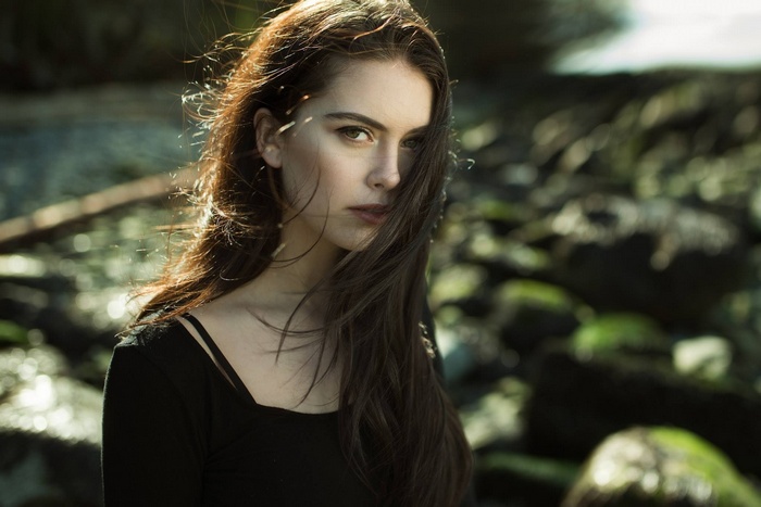 Woman with long brown hair in a black top