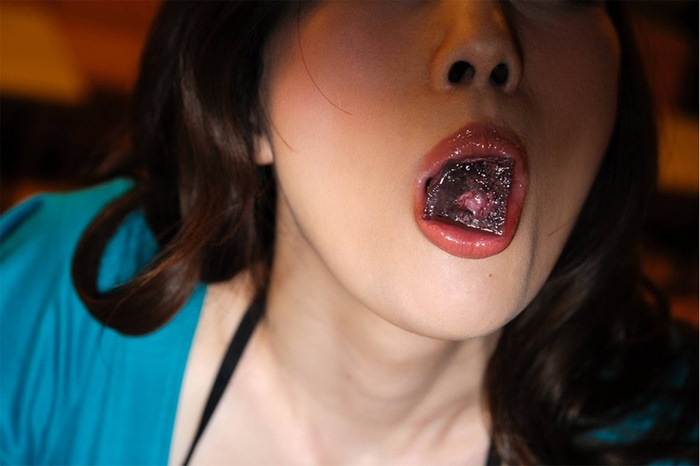 Woman with dark substance in her mouth