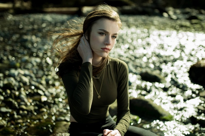Woman with long hair by a stream