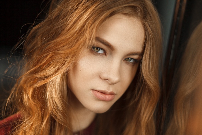 Portrait of a young woman with red hair