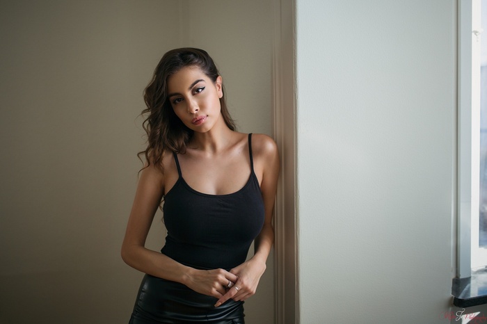 Woman in black tank top and leather skirt