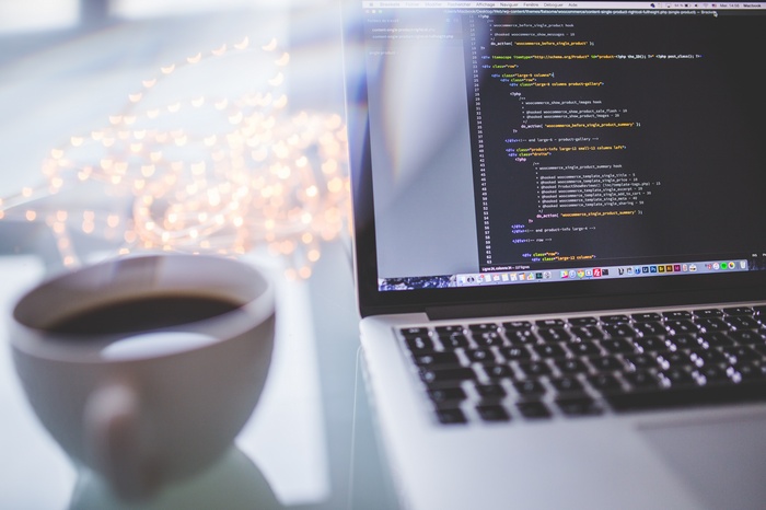 Laptop with code and coffee cup