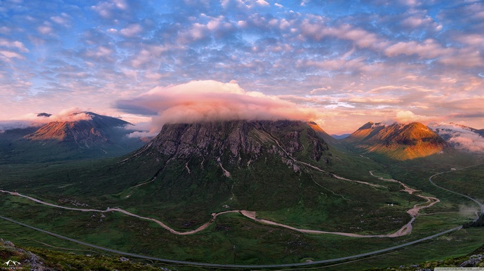 Scottish Highlands mountain pass with river and clouds