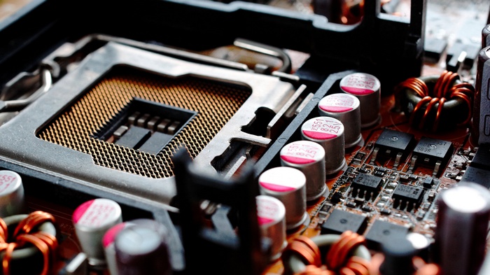 Closeup of a computer motherboard with CPU socket and components