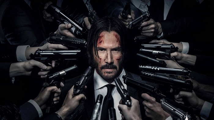 John Wick surrounded by guns