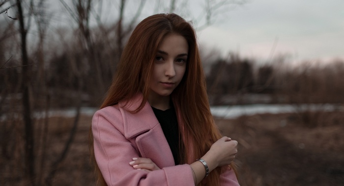 Redhead woman in pink coat outdoors