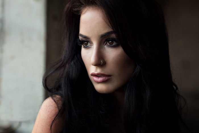 Woman with dark hair and nose ring
