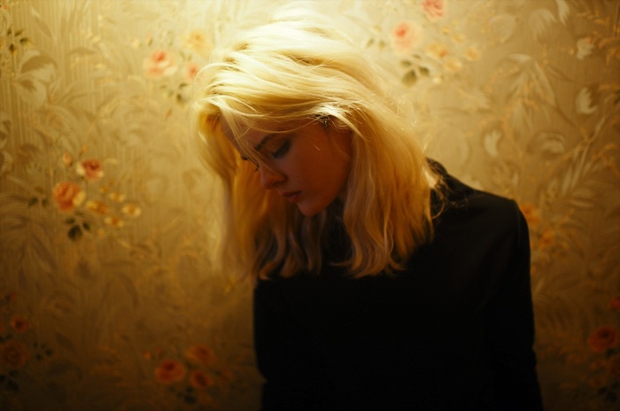 Woman with blonde hair looking down