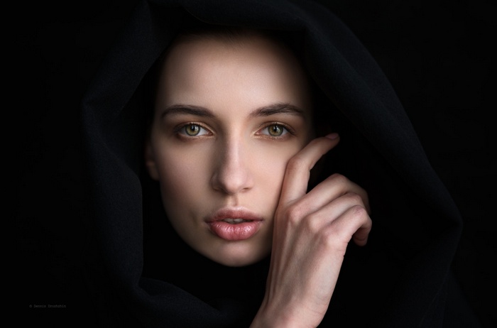 Woman with green eyes and black hood