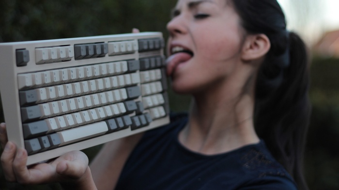 Woman licking a mechanical keyboard