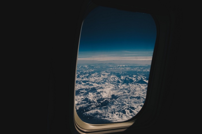 View of snow-capped mountains from an airplane window