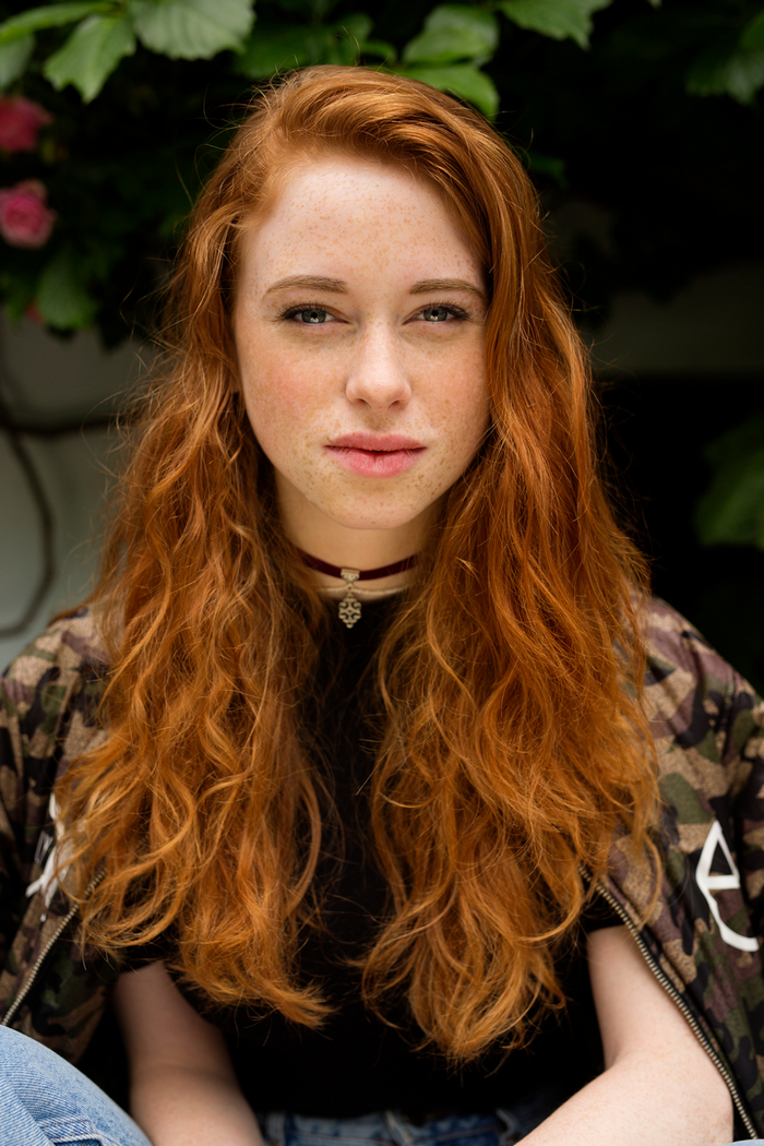 Young woman with red hair and freckles