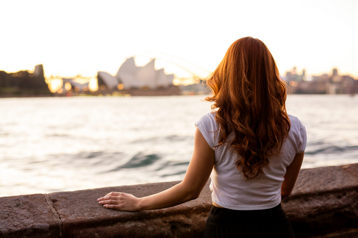 Woman with red hair looking at Sydney Opera House