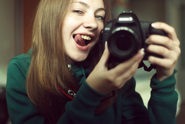 Woman taking a selfie with a Canon camera