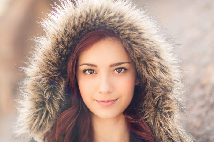 Woman with red hair wearing a fur-lined hood