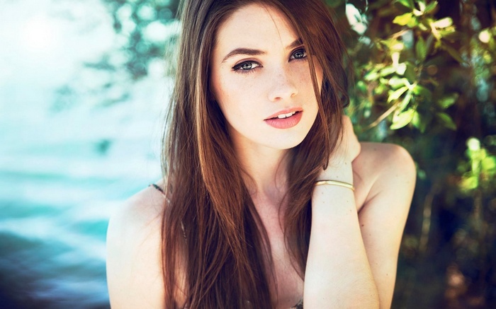 Woman with long brown hair and blue eyes