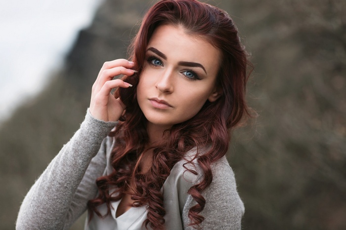 Woman with auburn hair and blue eyes