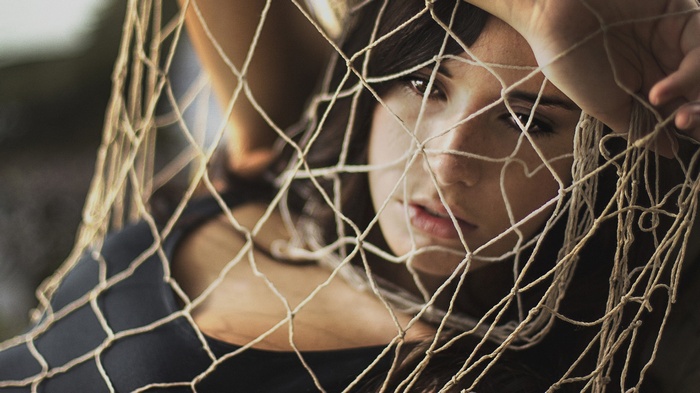Woman behind a fishing net