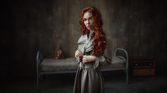 Woman with curly red hair in a dress