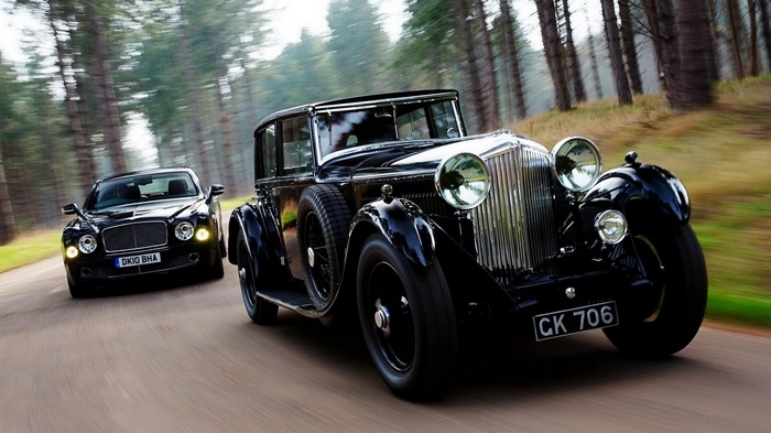 Bentley classic car and modern Bentley Mulsanne on a road