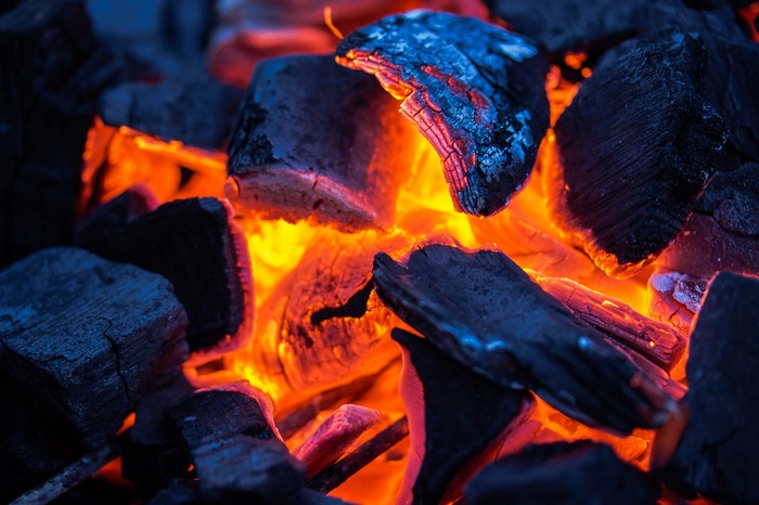 Close-up of glowing hot coals and embers